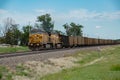 Union Pacific lashup with locomotives 6814 and 5468 smokes and steams westbound with empty coal hoppers