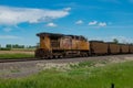 Union Pacific locomotive 8135 heads eastbound with a train with coal loaded hoppers with helper Union Pacific diesel locomotive