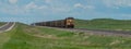 Union Pacific locomotive 8135 heads eastbound with a train with coal loaded hoppers with helper Union Pacific diesel locomotive