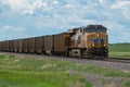 Union Pacific locomotive 8135 heads eastbound with a train with coal loaded hoppers with helper Union Pacific diesel locomotive