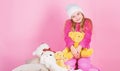 Unique attachments to stuffed animals. Kid little girl play with soft toy teddy bear pink background. Child small girl Royalty Free Stock Photo