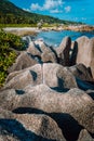 Unique big granite rocks in lush green foliage on hidden picturesque tropical coastline. Grand L Anse, La Digue