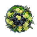 Unique bouquet consisting of blueberries, blackberries, lemons decorated with green carnations is isolated on a white background