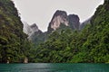 Unique Cheo Lan Lake on a rainy day. On the emerald water of the lake, ripples from raindrops Royalty Free Stock Photo