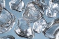 Unique close-up view of floating ice cubes in clear water against a soft blue background Royalty Free Stock Photo