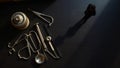 Unique collection of antique dental tools with a lone figure observing the scene in dramatic lighting Royalty Free Stock Photo