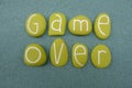 Game Over text composed with green colored and carved stone letters