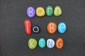 Born to Be King, birthday phrase composed with multi colored sea stones over natural black volcanic sand