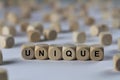 Unique - cube with letters, sign with wooden cubes Royalty Free Stock Photo