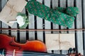 Unique cufflinks in the form of a violin key lie on a violin