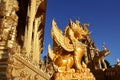 A unique design golden typical Thai style lion statue stands out from the blue sky in central region of Thailand Royalty Free Stock Photo