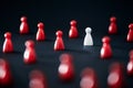 Unique, distinct from the crowd. Business concept. Standout competitor. Independent, initiative leader. Red pawns. Royalty Free Stock Photo