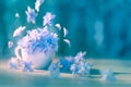 Unique floral artistic background with blue flying flowers and bokeh. Conceptual romantic wallpaper design