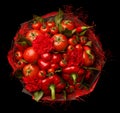 Unique gift handmade in the form of a bouquet consisting of a tomatoes, red peppers, bay leaves on a black background