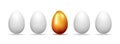 Unique golden egg in row of ordinary white eggs. Concept of exclusivity Royalty Free Stock Photo