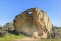 Unique granite boulder with a hole worn through