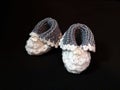 Hand knitted booties for newborn. Royalty Free Stock Photo