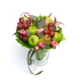 Unique handmade edible gift in the form of a bouquet of fruit standing in glass vase on a white background