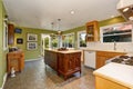 Unique kitchen with green walls, and island.