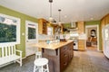 Unique kitchen with green walls, and island.