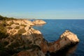 Unique limestone rock formations with arches and caves near Alvor village in Portugal