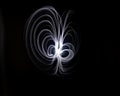 Unique, long exposure, white Led light painting photograph of abstract pattern on black background Royalty Free Stock Photo