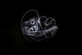 Unique, long exposure, white Led light painting photograph of abstract pattern on black background Royalty Free Stock Photo