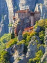 Unique Meteora monasteries. Zoom view on the Holy Roussanou Monastery placed on the edge of high rock. The Meteora area is on Royalty Free Stock Photo