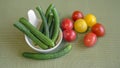 Still life of mini vegetables on a green background.