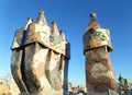 Unique mosaic chimneys against the vibrant blue sky of Barcelona