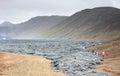 A unique natural attraction. People are walking over the new lavafield of the volcano eruption Royalty Free Stock Photo