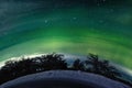 A unique natural phenomenon of the green polar northern lights in the night sky Royalty Free Stock Photo