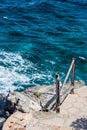 Unique ocean water portrait with small land ledge and fence