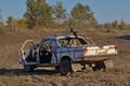 A unique passenger car with a machine gun mounted on the roof.