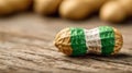 Unique peanut on wooden surface with green and white design, surrounded by more peanuts during a casual snack time Royalty Free Stock Photo