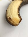 Unique perspective. Ripe peeled banana on a white background.