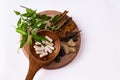 Unique photography of Cinnamon, dry ginger, black cardamom, mace arils, long pepper, and herbal capsules in wooden spoon with Royalty Free Stock Photo