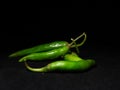 Unique picture of green chillies on dark background