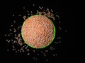 Unique picture of masoor dal, lentils or legumes in a green cup under dark background