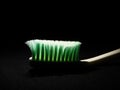 A unique picture of a toothbrush under dark background