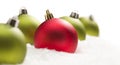 Unique Red Amongst Green Christmas Ornaments on Snow Royalty Free Stock Photo