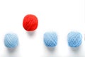 A unique red ball jumps out of a row of identical wool balls. Abstract concept of leadership Royalty Free Stock Photo