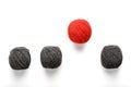 A unique red ball jumps out of a row of identical wool balls. Abstract concept of leadership Royalty Free Stock Photo