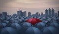 Unique red umbrella among black umbrellas Royalty Free Stock Photo