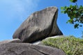 Unique rock Sail. A clear summer day, on top of a cliff, amid a bright blue sky, there is a huge ancient boulder