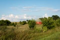 Unique round red barn surrounded by open farmland in rural Illinois. Royalty Free Stock Photo