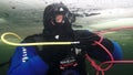 Unique shooting of diver underwter on seabed in ice of White Sea.