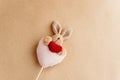 Unique simple hand made bunny with heart on craft background, va