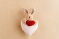 Unique simple hand made bunny with heart on craft background, va