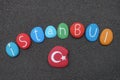 Istanbul, Turkey city text with multicolored stones over natural volcanic black sand